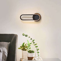 Modern oval bedroom bedside lamp with sleek design, warm white light, and high-quality aluminum material, enhancing sophisticated home decor.