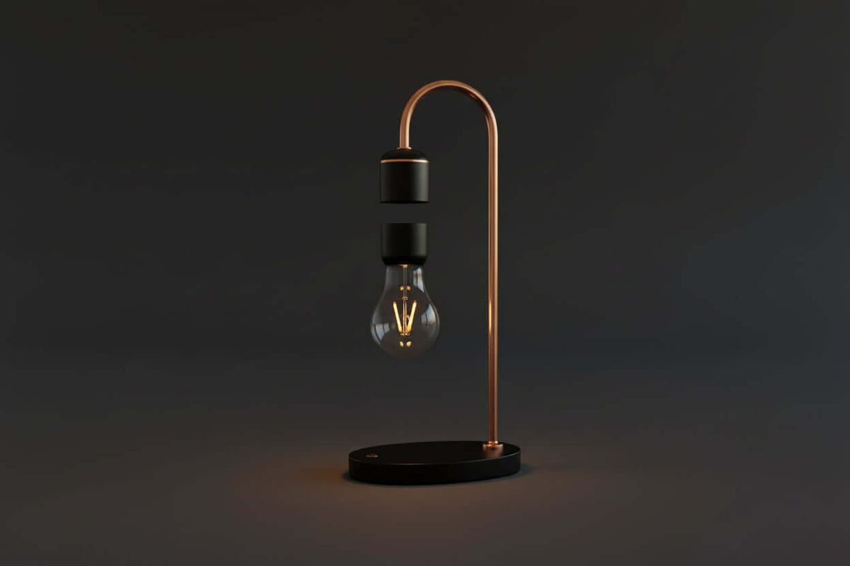 A levitating smart lamp with a transparent bulb, silver metal parts, and a vintage wood base, illuminated and floating above a black surface.