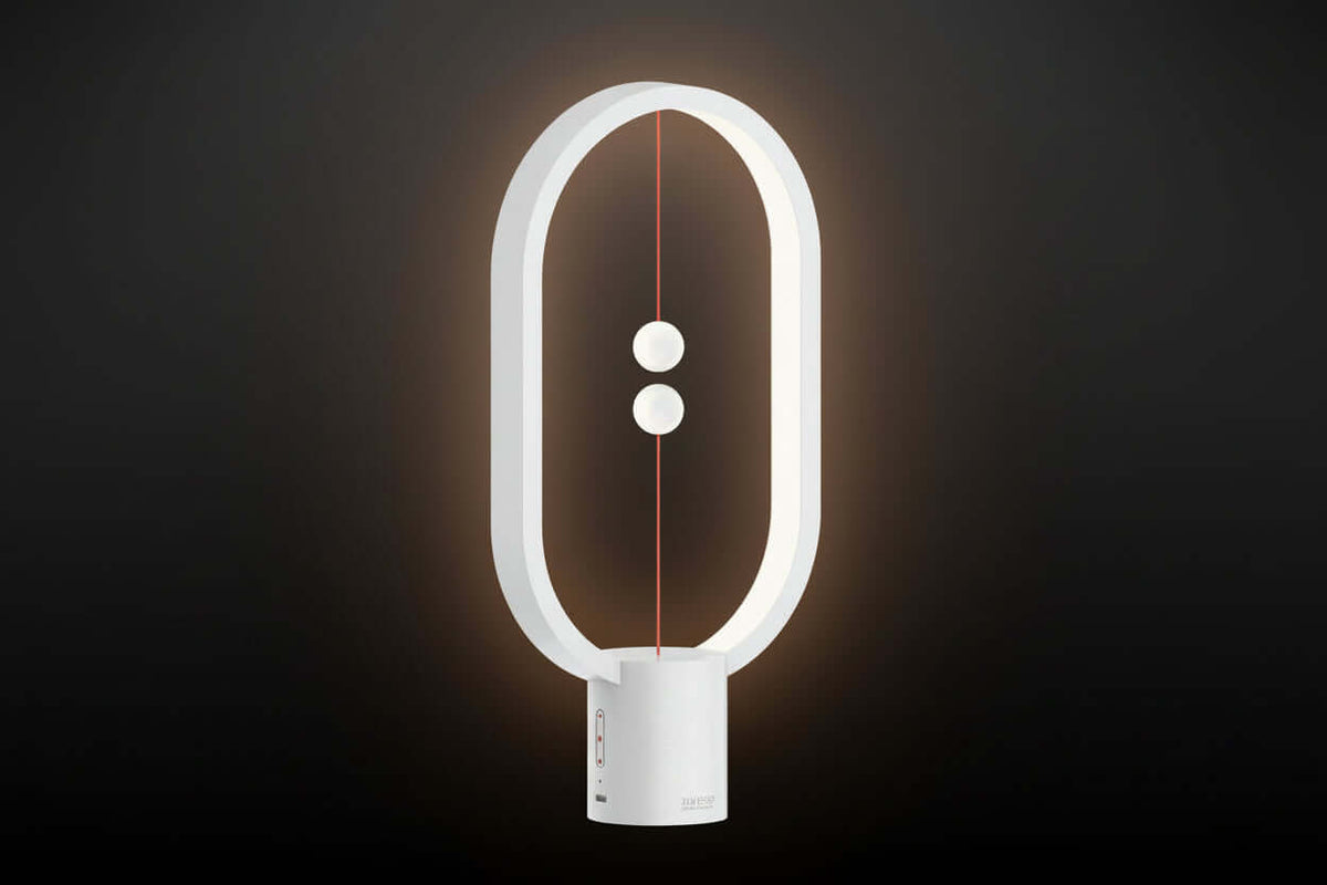 Modern white lamp with circular design on a dark background
