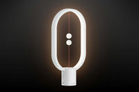 Modern white lamp with circular design on a dark background